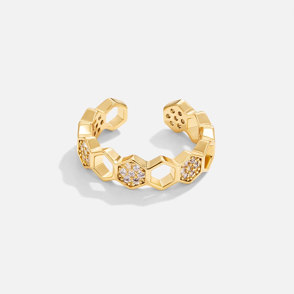 Gouden honingraatring met kristal