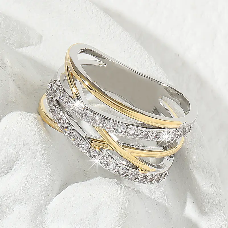 Overlappende ring van goud en zilver met sprankelend zirkonium